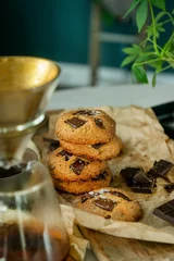 Foto op Plexiglas Vertical closeup of coffee cup and freshly baked cookies blurred background © Simone Oppes/Wirestock Creators
