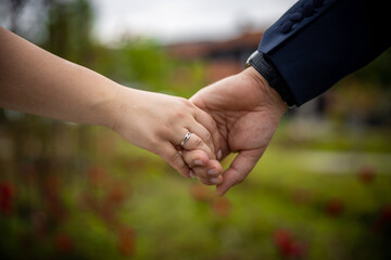 Wedding. Hands of man and woman on dark background on warm soft sunlight. New family is born. High quality photo