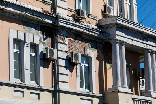 A crumbling historic building in Russia. Historic building in poor condition. Windows of an old house.