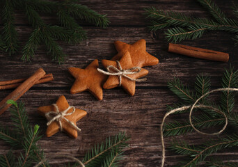 ginger cookies in the form of stars with cinnamon and spruce branches
