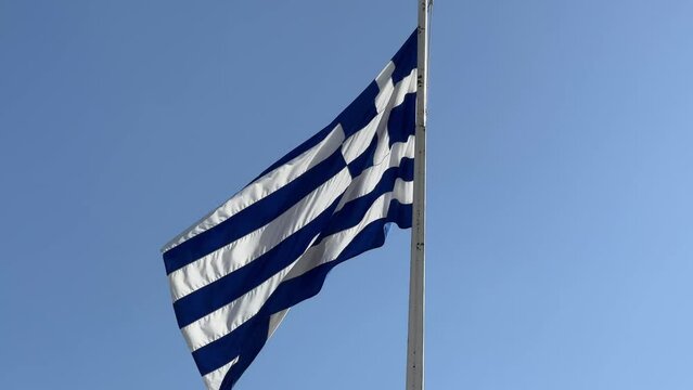 Greece national flag waving in the Acropolis of Athens.