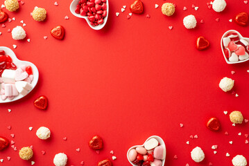 Valentine's Day concept. Top view photo of heart shaped saucers with confectionery candies and...