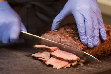 man chef cuts cooked fried meat