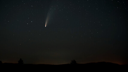 The comet moves across the night sky among the stars