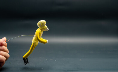 Stopmotion process of jumping. Jump start. Man's hand holding with an aluminum wire a figure made...