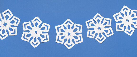 Beautiful paper snowflakes on blue background