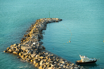 Jetty of rocks on the sea