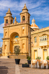 Fototapeta na wymiar Marsaxlokk fishing village in Malta and Sanctuary of Our Lady of Pompei parish church