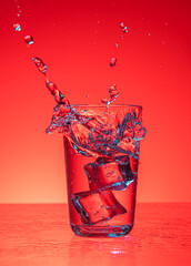 ice cubes falling into water with splash 