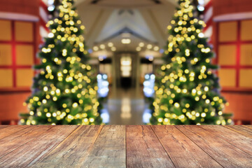 Empty wood table top with blur Christmas tree with bokeh light background