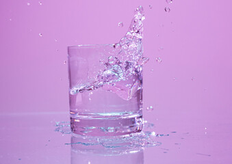 ice cube falling into water with splash 