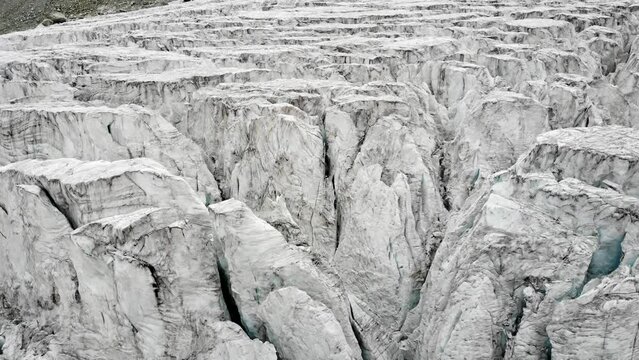 Aerial flyover over the Moiry glacier near Grimentz in Valais, Switzerland with a pan down view straight into an ice crevasse
