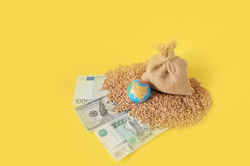 A bag of wheat, a globe layout and money - a thousand rubles, one hundred dollars and euros. Yellow...