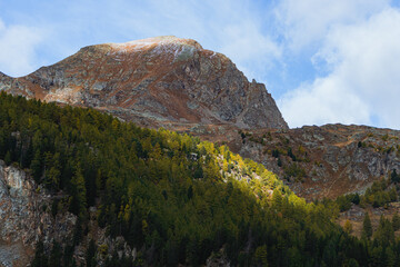 The mountains of the Val di Camp, a small valley near the village of Poschiavo, during an autumn day, Canton of Grisons, Switzerland - October 2022.