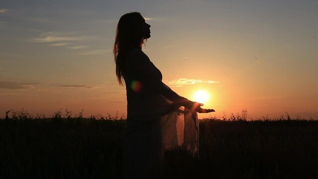 a new day begins with the sunrise protected in the hands of a woman