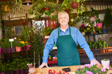 Older man as a gardener and specialist salesman with competence