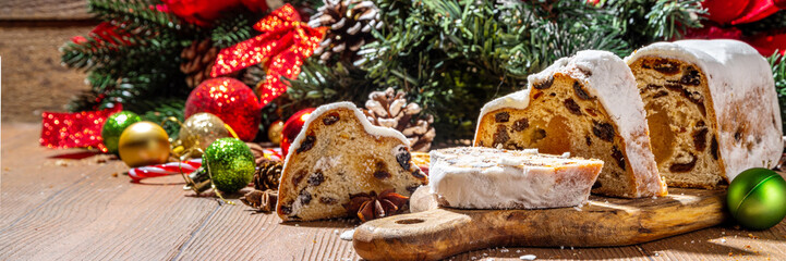 Traditional Christmas Dresdner stollencake with dried fruits, spices, Christmas tree and decoration...