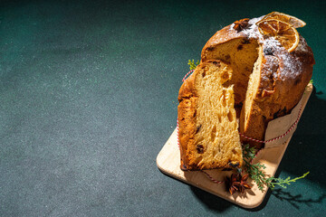 Traditional Christmas panettone cake with dried fruits, spices, Christmas tree and decoration on...