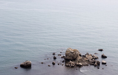 Empty calm blue sea with rocks and stones. Empty space, space for text