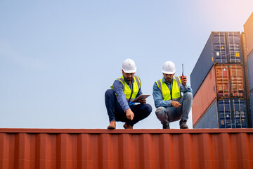 Team Businessman checking goods at a container shipping company, Caucasian worker planning transportation of goods to distributors through the ship. The concept of logistics worldwide cargo container