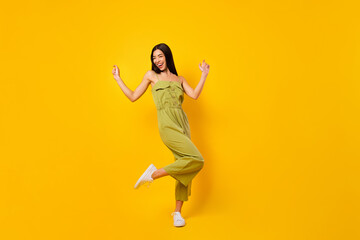 Fototapeta na wymiar Full body photo of overjoyed positive thai person enjoy dancing clubbing isolated on yellow color background