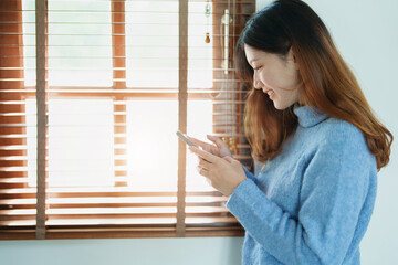 Portrait of a beautiful Asian teenage girl using a smartphone mobile