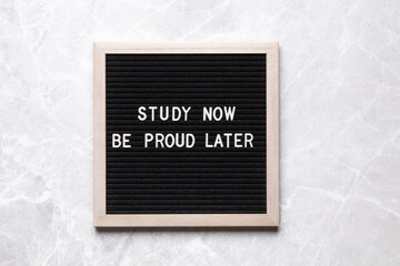 Motivational quote on black letter board. Study now be proud later. Inspirational quote of the day.
