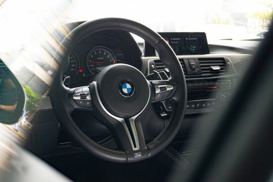BMW M4 Steering wheel seen through door glass and dor sail