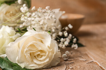 Beautiful white flowers on color table, closeup