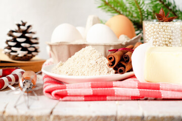 Bakery background with ingredients for cooking Christmas baking. Flour, brown sugar, butter, eggs
 and spices on the table