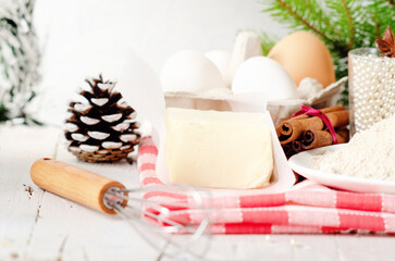 Fototapeta na wymiar Bakery background with ingredients for cooking Christmas baking. Flour, brown sugar, butter, eggs and spices on the table