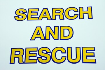 Blue and yellow Search and Rescue words against a white background, Sidmouth, Devon, UK, Europe
