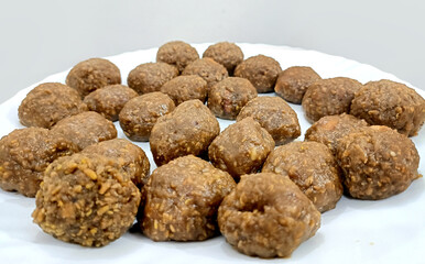 Indian white sesame seeds sweet or tilgul laddu, made up of jaggery and sesame seeds, hand made, round, indian sweet on Makar Sankranti festival