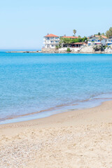 Obraz premium Nice houses on the beach in a resort area. Relaxation and outdoor recreation. Vertical.