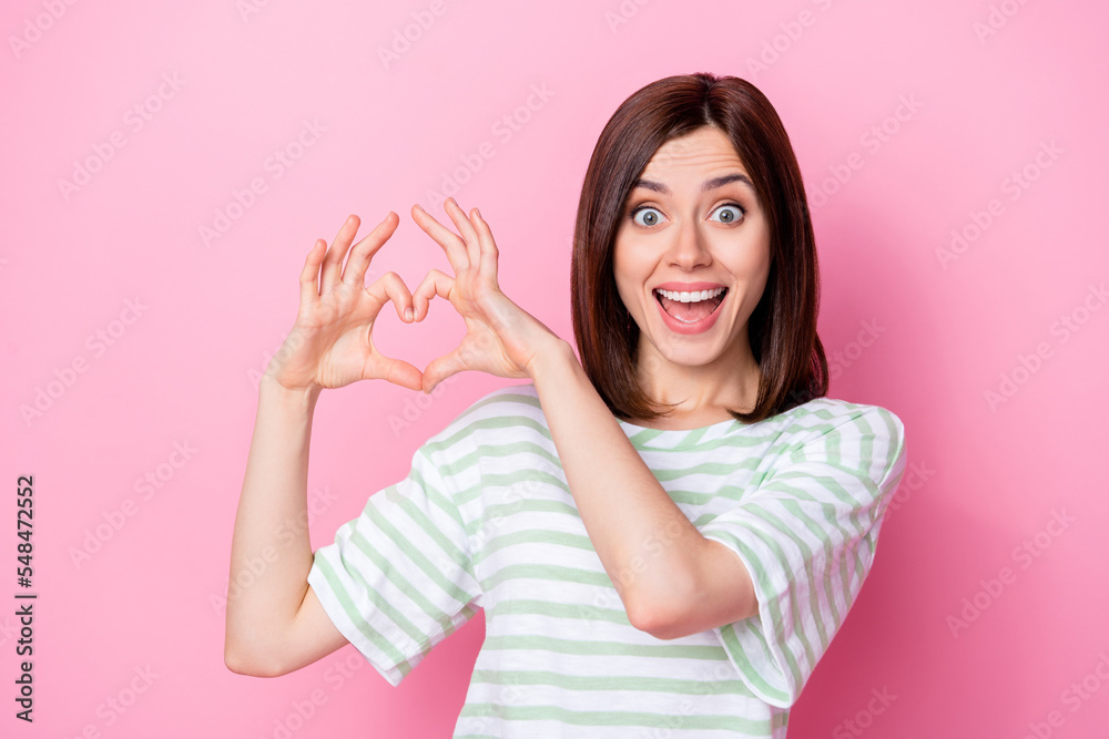 Sticker Photo portrait of winsome young woman show heart fingures charity symbol wear trendy striped outfit isolated on pink color background