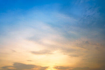 Beautiful cloudy sky after the rain between the sunset in gradient blue and yellow color tone. 