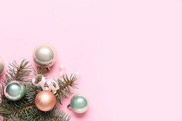 Christmas balls and fir branch on pink background