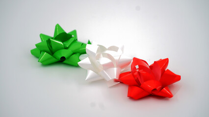 Gift bows in the colors of the Italian flag on isolated background