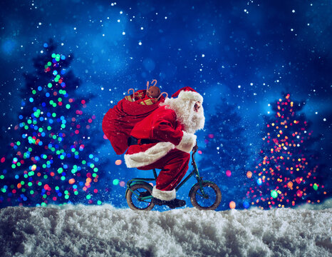 Santaclaus rides bike to deliver fast christmas gifts