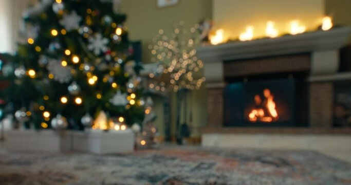 Defocused background with fireplace and christmas tree in house living room