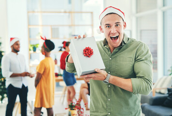 Wow, gift and businessman happy at a Christmas party for work celebration in the office. Smile,...