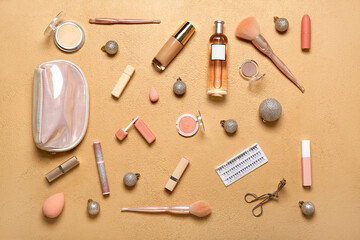 Makeup products with Christmas balls on beige background