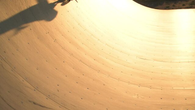half pipe for skaters at sunset in slow motion