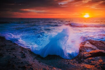 The whooosh of waves as they break over the coastal rocks