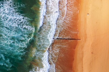 Aerial view of beach with surfers