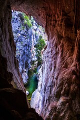 The Tinted Cave offers a window out to the Mares Forest Creek Canyon