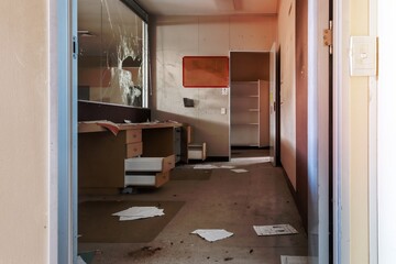 Fototapeta na wymiar Vandalised office reception area of abandoned building