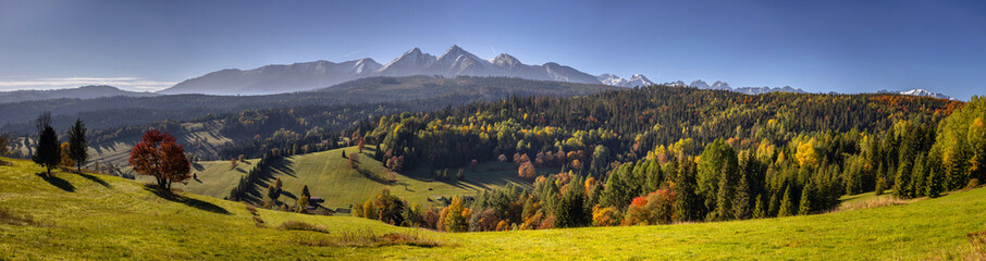 Beautiful autumn with red trees under the Tatra Mountains at sunrise. Slovakia