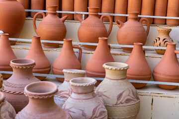 Fototapeta na wymiar Oman Hand Made Pottery in Nizwa Market. Clay Jars at the Rural Traditional Arabic Bazaar, Oman. 