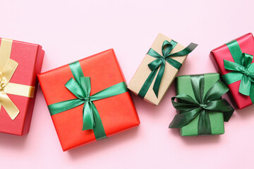 Beautiful Christmas gift boxes on pink background